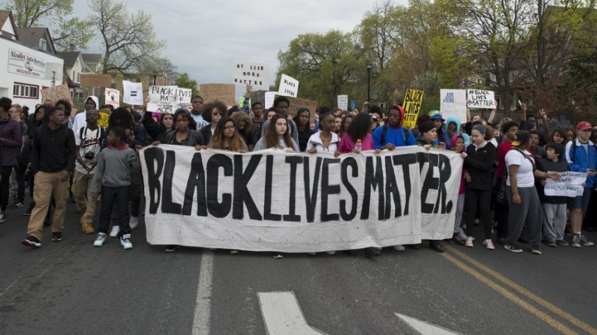 Protesters holding a black lives matter sign
