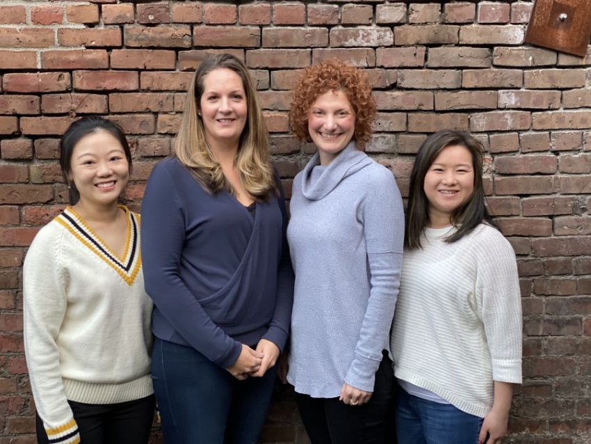 POMA on-sight acupuncture team against a brick background